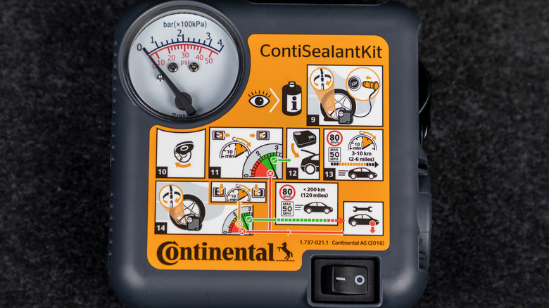 A Continental ContiSealantKit compressor with instructions for repairing a flat tire