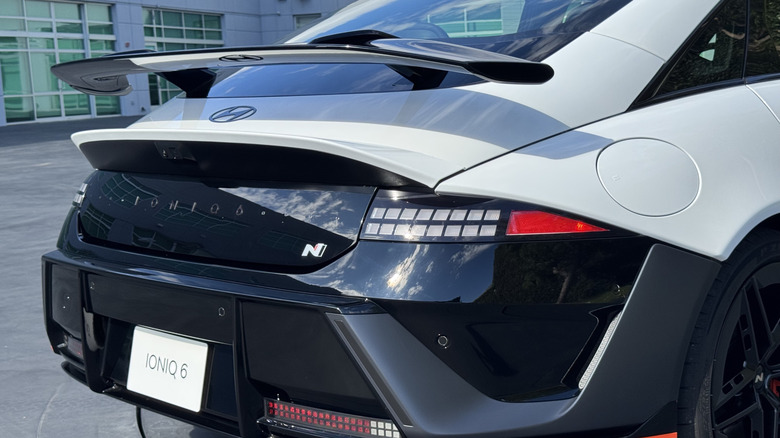 A close-up rear three quarters shot of the white Ioniq 6 N showing its blacked-out back end and prominent spoiler