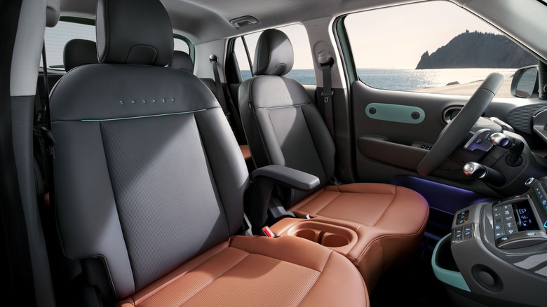 A look at the dark gray and dark orange interior of the Casper Lounge with a body of water out the window
