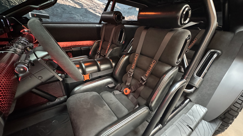 A look back at the black front seats in the Crater Concept showing the orange ambient lighting and four-pount harness