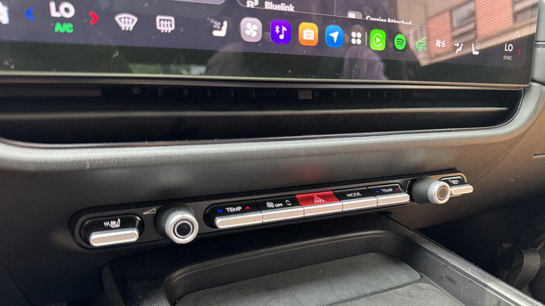 A close-up shot of the row of physical controls in the Grandeur with the black interior