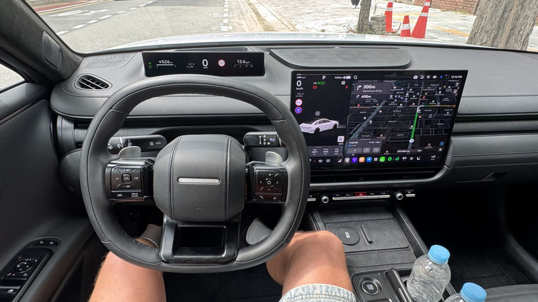 A photo of my POV inside a Grandeur with a black interior showing the two screens and HUD