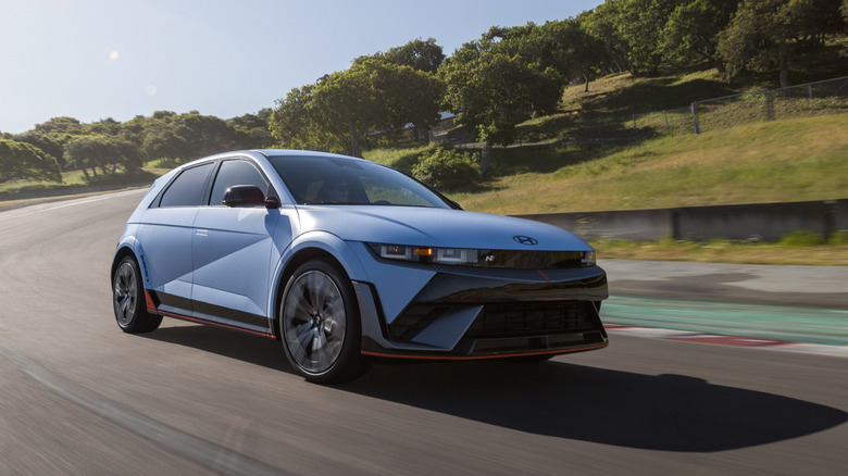 Front three-quarters shot of a blue Ioniq 5 N driving on a racetrack