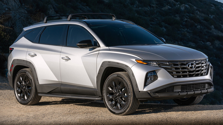 2022 Hyundai Tucson XRT parked on a dirt road in front of a big hill