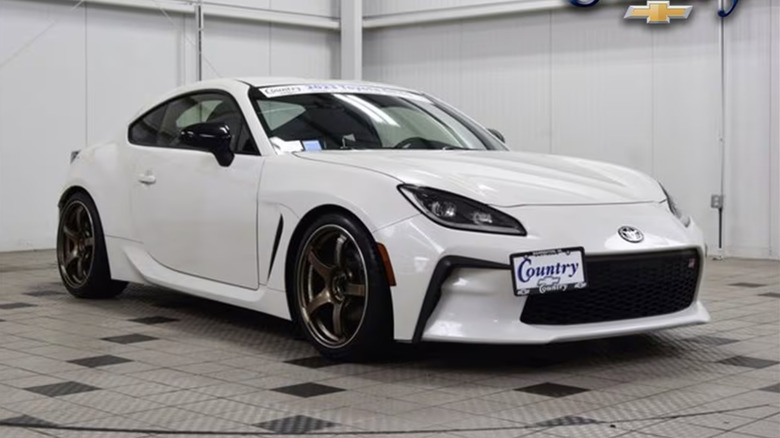 A white Toyota GR86 parked in an empty room