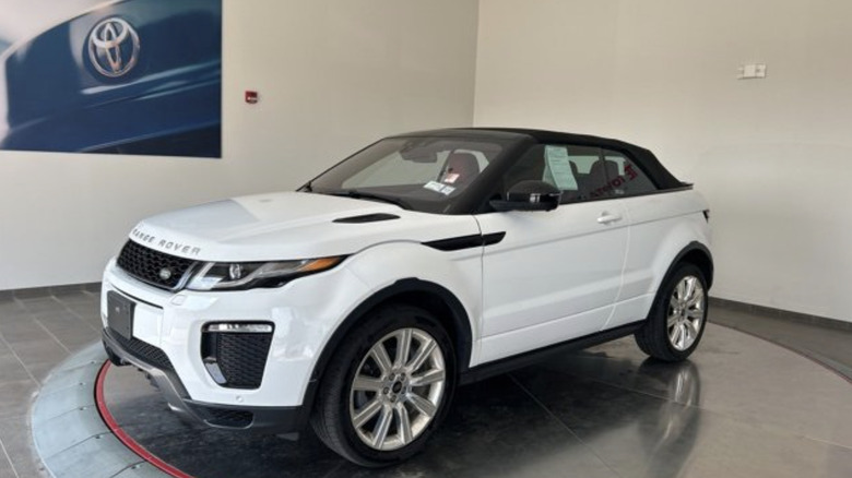 a white 2018 Land Rover Range Rover Evoque HSE Dynamic convertible sitting inside a car dealership show room.