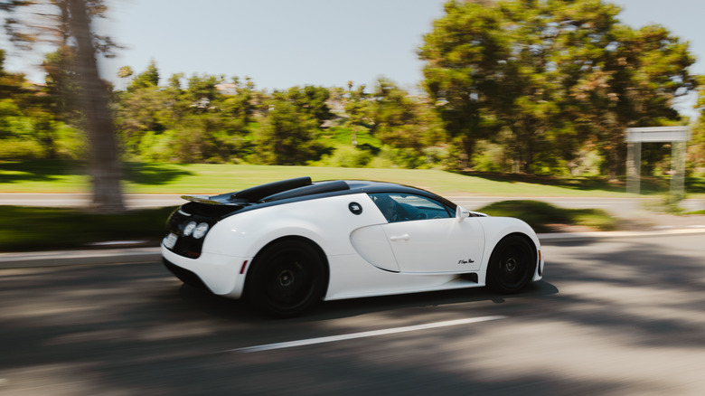 Side view of a white Bugatti Veyron Grand Sport Vitesse driving