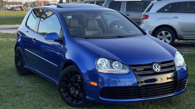 A blue Volkswagen R32 parked on grass