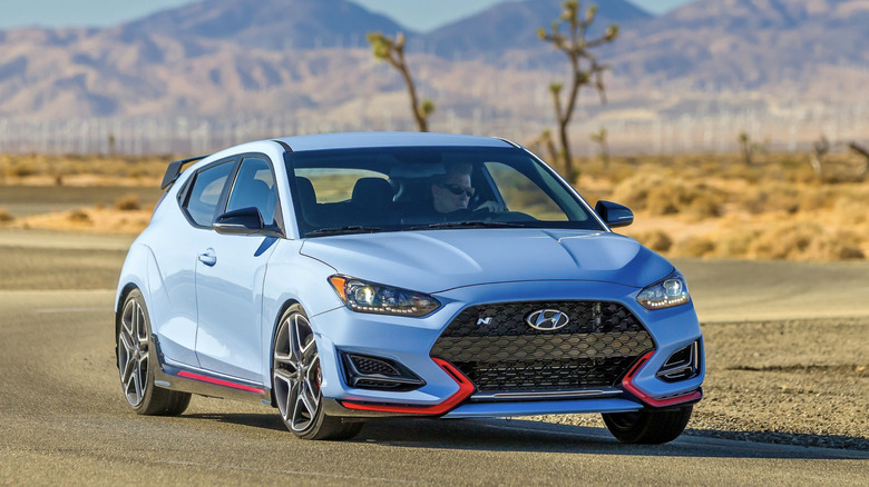 A blue Hyundai Veloster N driving down the road