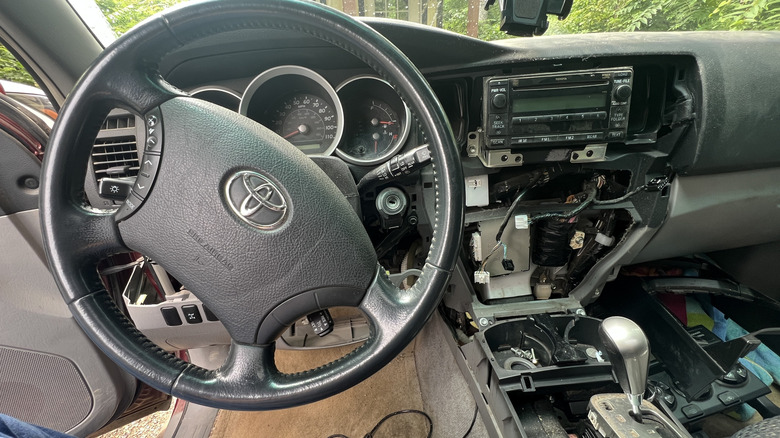 A 2006 Toyota 4Runner dashboard dismantled to remove the original head unit