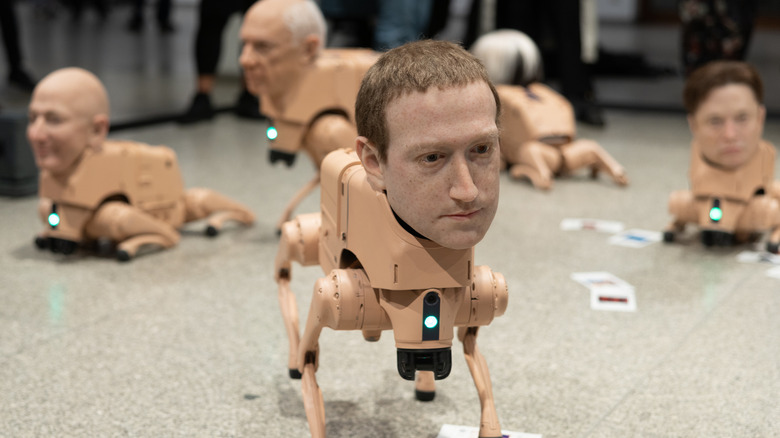 Autonomous robotic dogs fitted with hyper-realistic silicone heads modelled after US entrepreneur Mark Zuckerberg (C), US entrepreneur Jeff Bezos (L), US entrepreneur Elon Musk (R) and other well-known people, walk around as part of the interactive art installation Regular Animals by US artist Beeple (born Mike Winkelmann), at Neue Nationalgalerie on May 7, 2026 in Berlin, Germany. The work marks a new phase in Beeple's practice, expanding his engagement with AI and digital art into an immersive physicaldigital environment, and represents his first institutional exhibition in Germany. (Photo by Christian Ender/Getty Images)