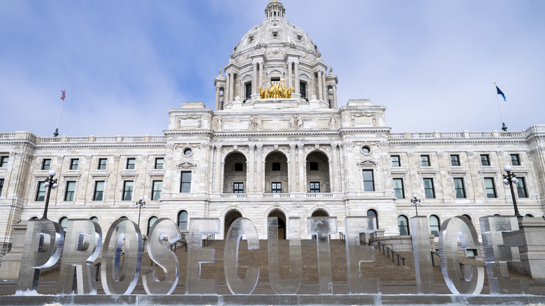 An ice sculpture reading "Prosecute ICE" outside the Minnesota State Capitol building