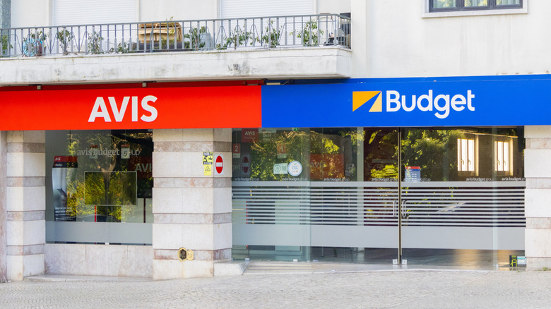 Avis and Budget signage on the exterior of a building.