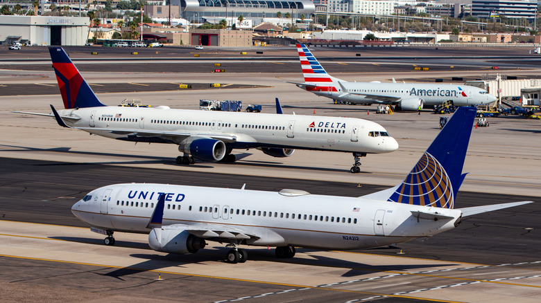 Photo of United, Delta, and American Airlines passenger planes at Phoenix Sky Harbor International Airport (PHX)