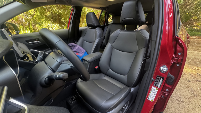 A look back in the driver's door at the interior showing the black leather in the red gas-only car
