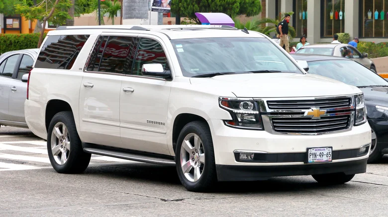 A Chevrolet Suburban driving through the city.