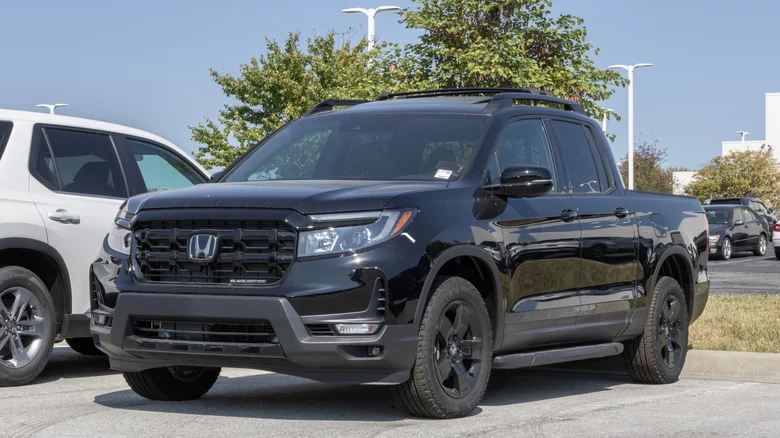 A black Honda Ridgeline in a a parking lot.