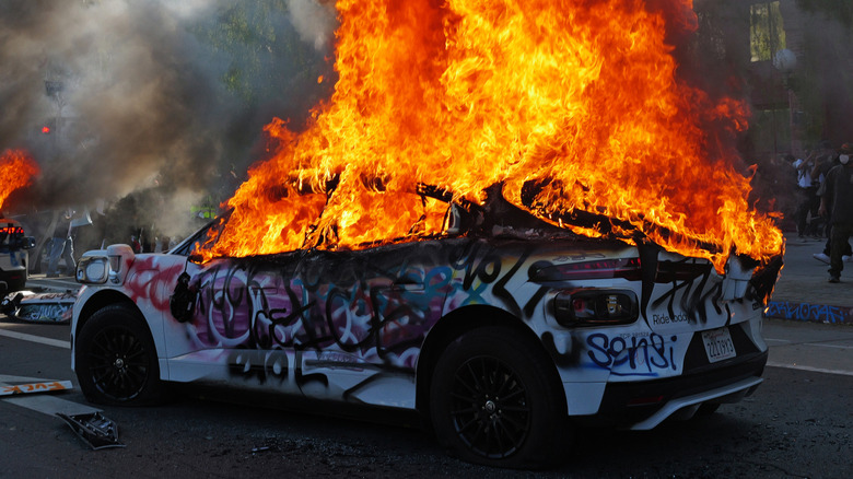 June 09: A Waymo car is set on fire and vandalized during a protest against immigration raids on June 08, 2025 in Los Angeles, California. Tensions in the city remain high after the Trump administration called in the National Guard against the wishes of city leaders following two days of clashes with police during a series of immigration raids.
