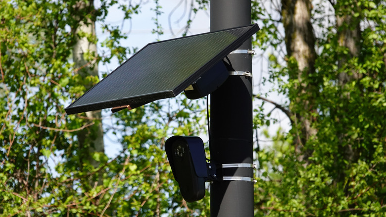 Flock safety police law enforcement license plate reader setup outside to help catch vehicle speeders.