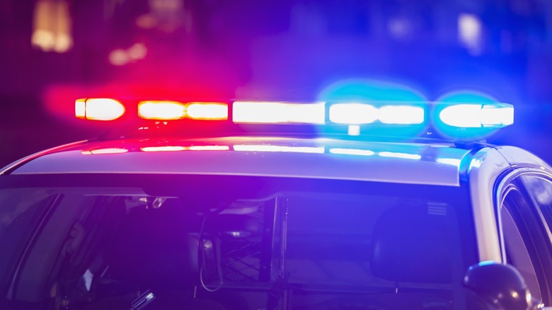Red and blue lights on top of a police car.