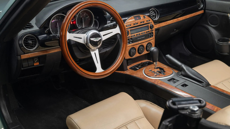 A photo looking at the dash of the Miata with the Nardi steering wheel and lots of wood on the center console