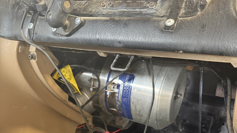 The air filter underneath the dashboard of an off-roading miata