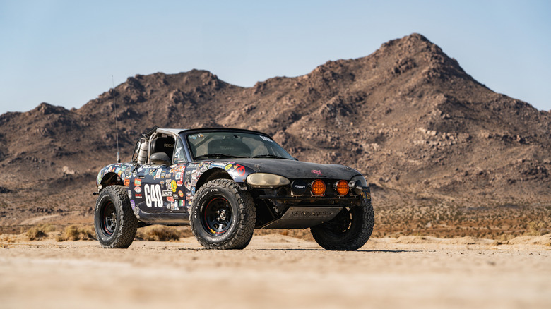 Buddy the off-road miata parked in front of a desert mountain