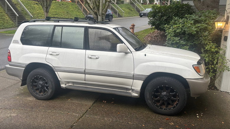 a white Toyota Land Cruiser parked in someone's driveway