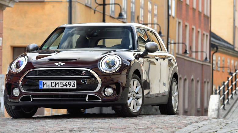 a mini clubman parked on a cobblestone street