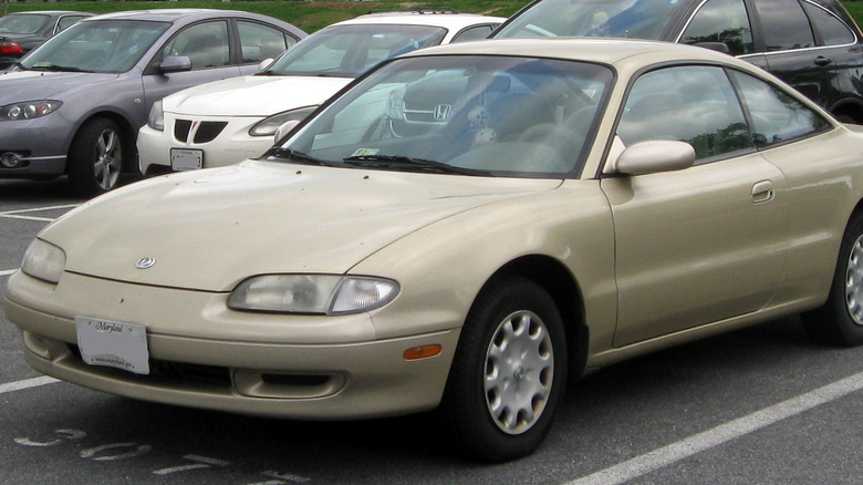 A gold 1997 Mazda MX-6