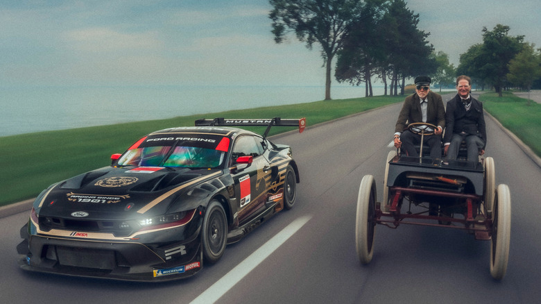 The 1901 Ford "Sweepstakes" race car driving side-by-side with the "Sweepstakes" Ford Mustang GT3