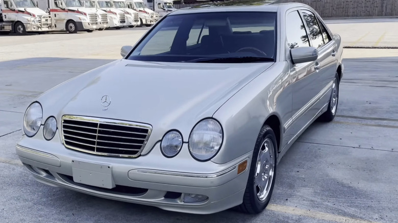 3/4 front-left static shot of a silver 2000 Mercedes-Benz E320 Designo