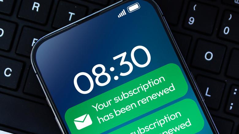 A smartphone with notifications stating that subscriptions have been renewed