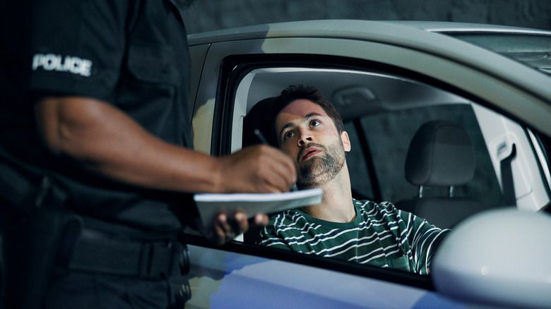 Stock image of a man being pulled over by police.