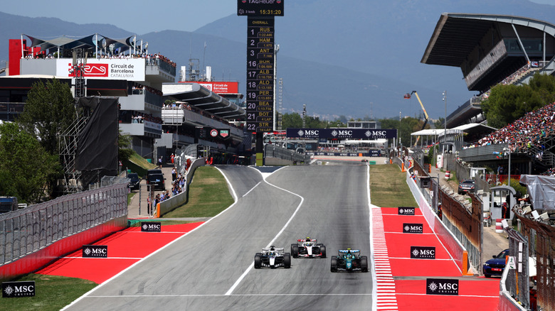 Fernando Alonso of Spain driving the (14) Aston Martin F1 Team AMR26 Honda leads Sergio Perez of Mexico driving the (11) Cadillac F1 Team MAC-26 Ferrari and Oliver Bearman of Great Britain driving the (87) Haas F1 VF-26 Ferrari on track during the F1 Grand Prix of Barcelona-Catalunya at Circuit de Barcelona-Catalunya on June 14, 2026 in Barcelona, Spain.