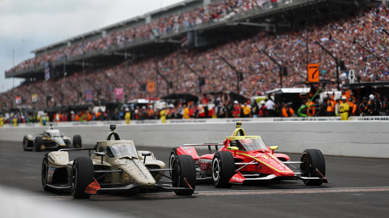 Felix Rosenqvist, driver of the #60 Meyer Shank w/ Curb-Agajanian Honda crosses the finish line to win ahead of David Malukas, driver of the #12 Team Penske Chevrolet during the NTT IndyCar Series 110th Running of the Indianapolis 500 at Indianapolis Motor Speedway on May 24, 2026 in Indianapolis, Indiana.