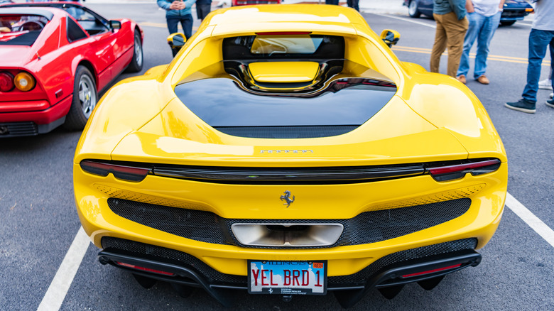 A rear-view shot of a yellow Ferrari 296 GTB.