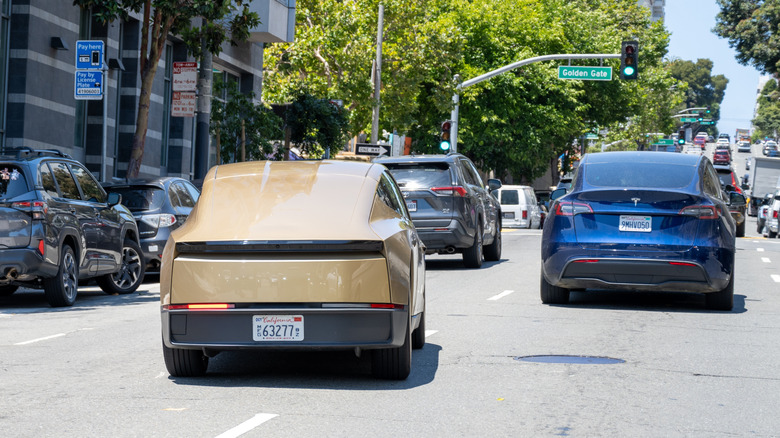 Rear view of a Tesla Cybercab in traffic in California.