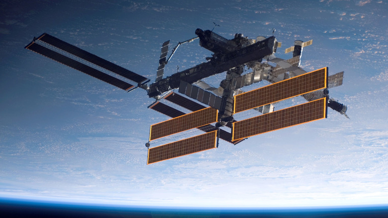 IN SPACE - SEPTEMBER 17: In this handout photo provided by NASA, the International Space Station is seen over a blue and white Earth, taken shortly after the Space Shuttle Atlantis undocked from the orbital outpost at 7:50 a.m. CDT. The unlinking completed six days, two hours and two minutes of joint operations with the station crew. Atlantis left the station with a new, second pair of 240-foot solar wings, attached to a new 17.5-ton section of truss with batteries, electronics and a giant rotating joint. The new solar arrays eventually will double the station's onboard power when their electrical systems are brought online during the next shuttle flight, planned for launch in December. (Photo by NASA via Getty Images)