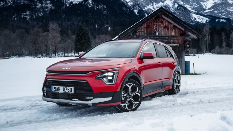 KIA Niro new model 2023 car - on road in motion in winter. Crossover SUV with AWD-I all wheel traction.