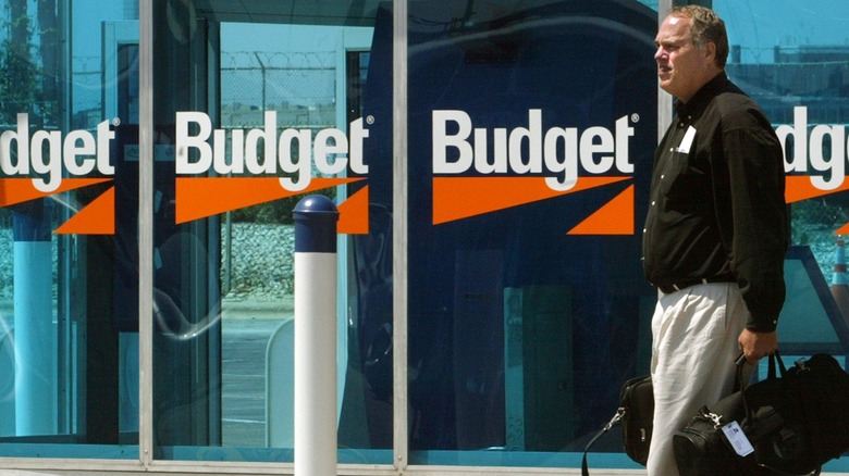 Man walking by Budget car rental area at Chicago O'Hare airport