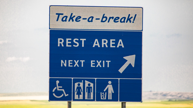 A rest area sign on the side of a highway