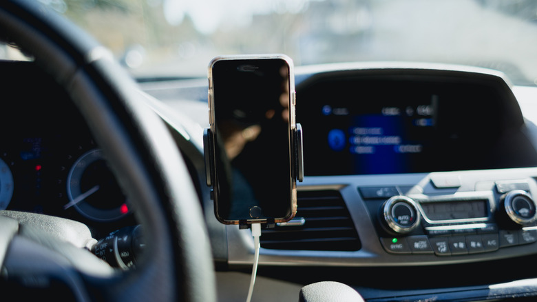 A smart phone secured in a holder for hands-free use
