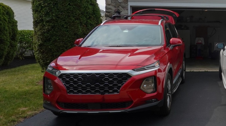 A reddish SUV parked successful a driveway