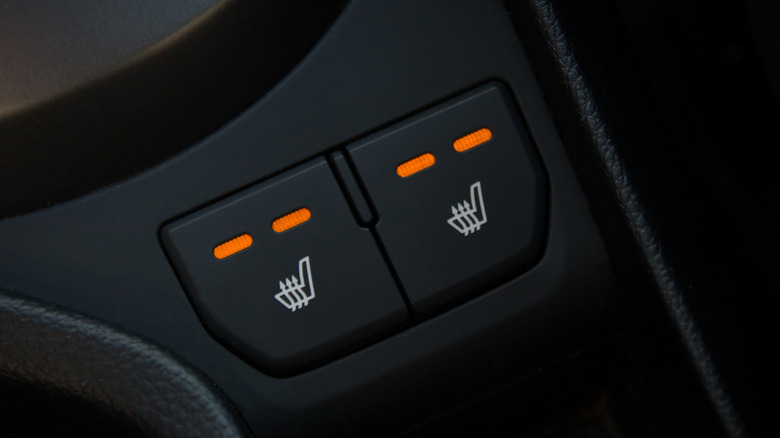 Heated seat buttons in a modern car interior