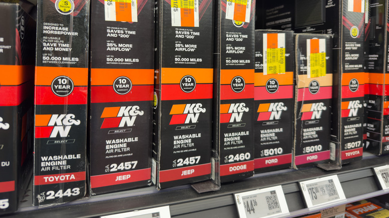Various K&N filters on a shelf at a car parts store.