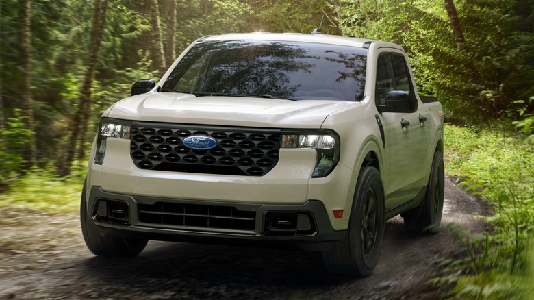 A 2025 Ford Maverick driving through mud