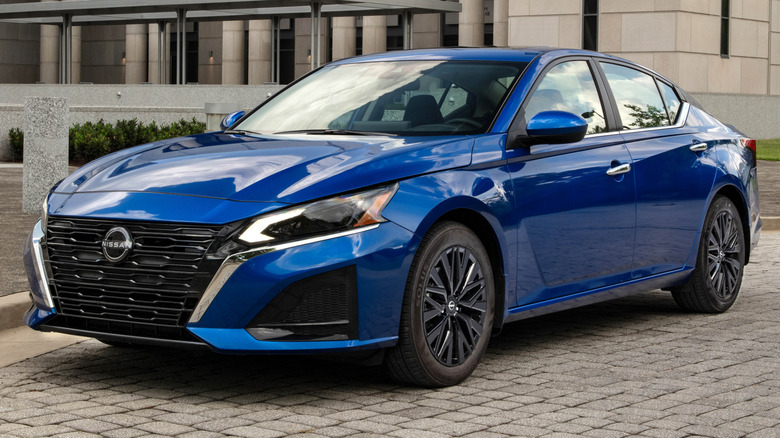 2025 Altima SV Special Edition parked on a paved surface in front of a large building
