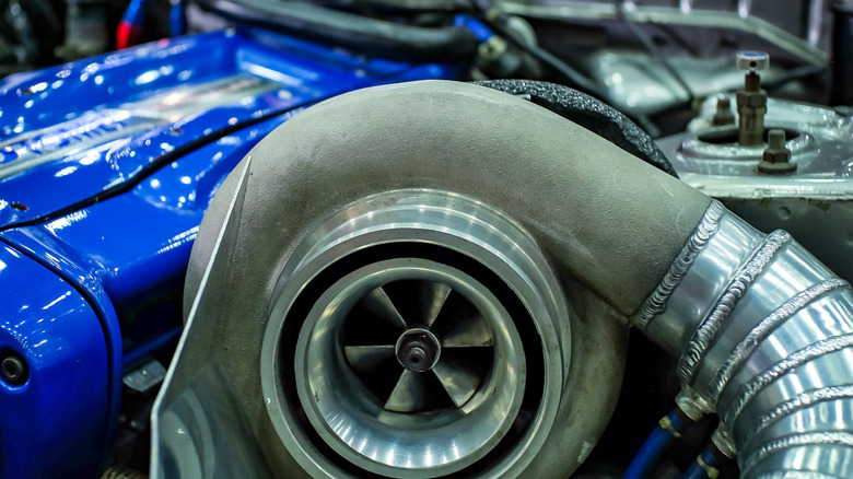A massive turbocharger bolted to a Nissan RB26DETT engine.