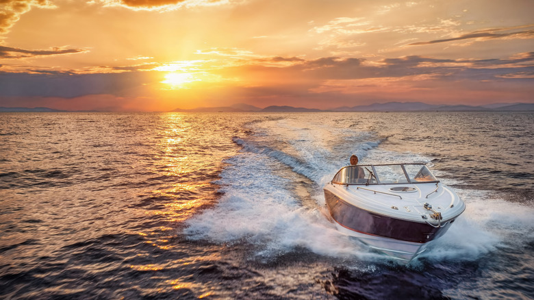 Boat cruising with the sunset in the background.